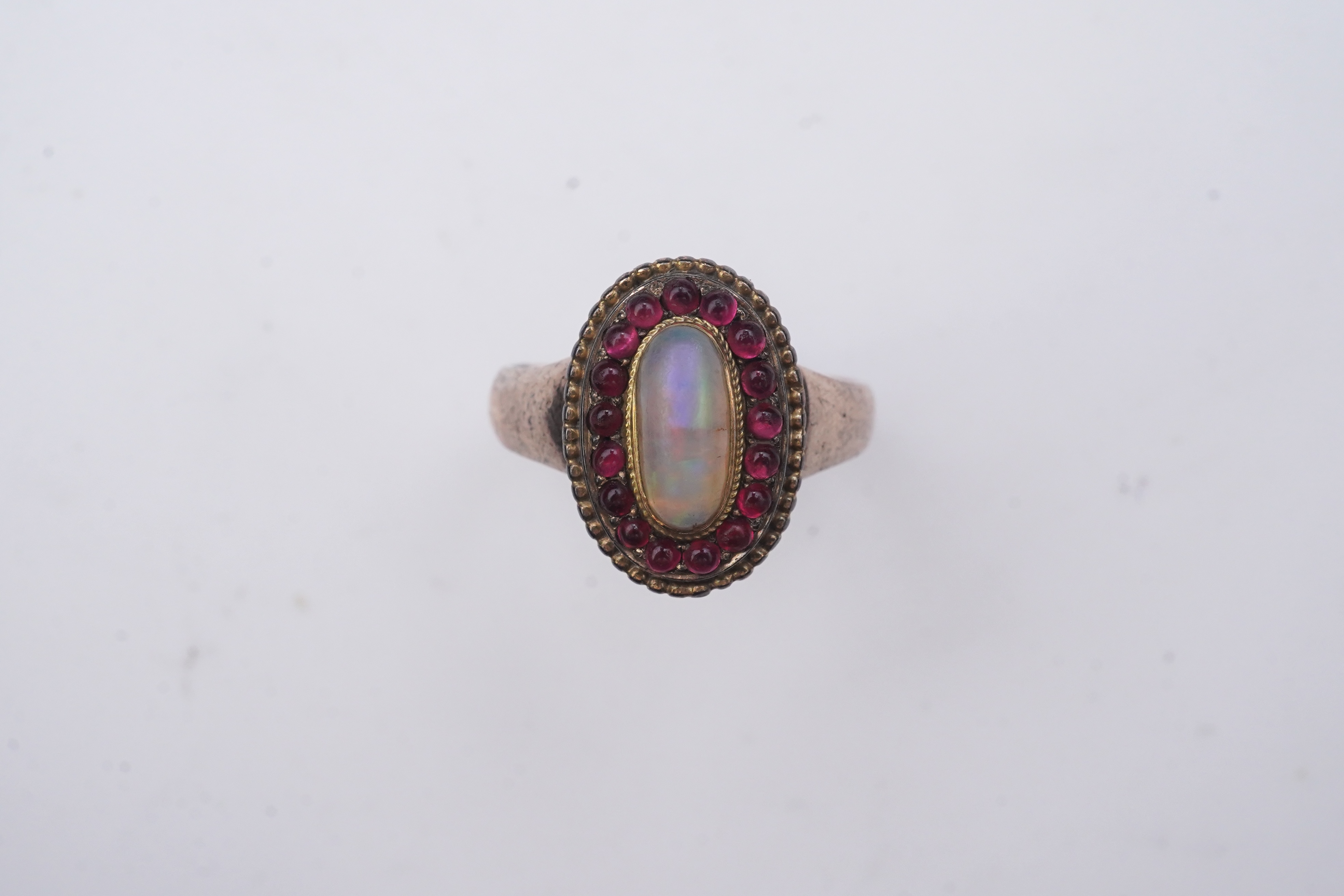 An opal and garnet ring